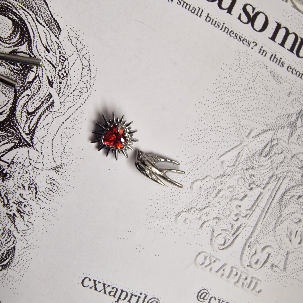 Don't shoot the messenger | Asymmetric Titanium Silver Bird Earring and Red Zircon Cartilage Stud Set